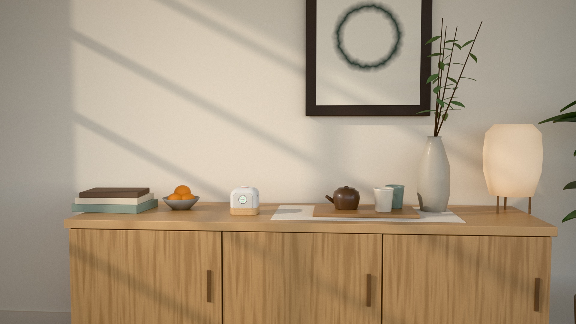 Concept render, not a photo of a real product: a living room sideboard in light wood with books, a bowl of oranges, a teapot and cups, a paper lamp and the small Mamori cube among them, with soft sunlight on the wall